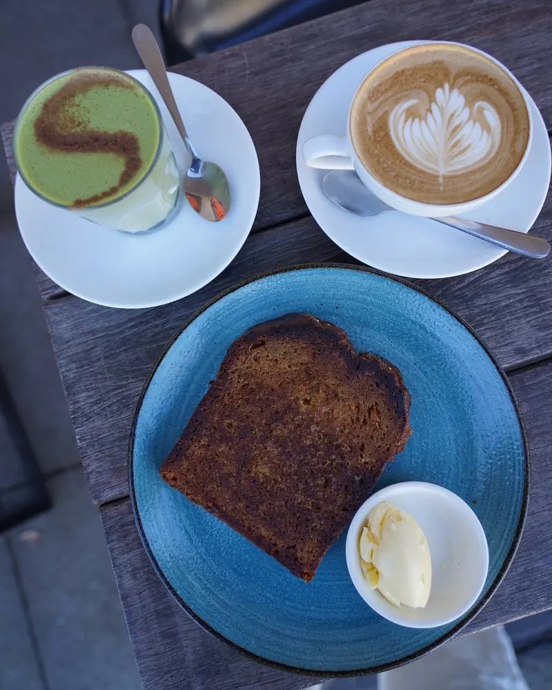 Matcha, a latte and toast on a timber table