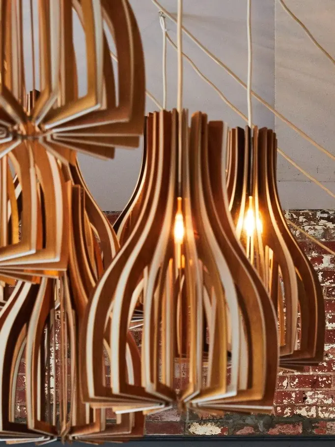 A timber pendant light against the brick